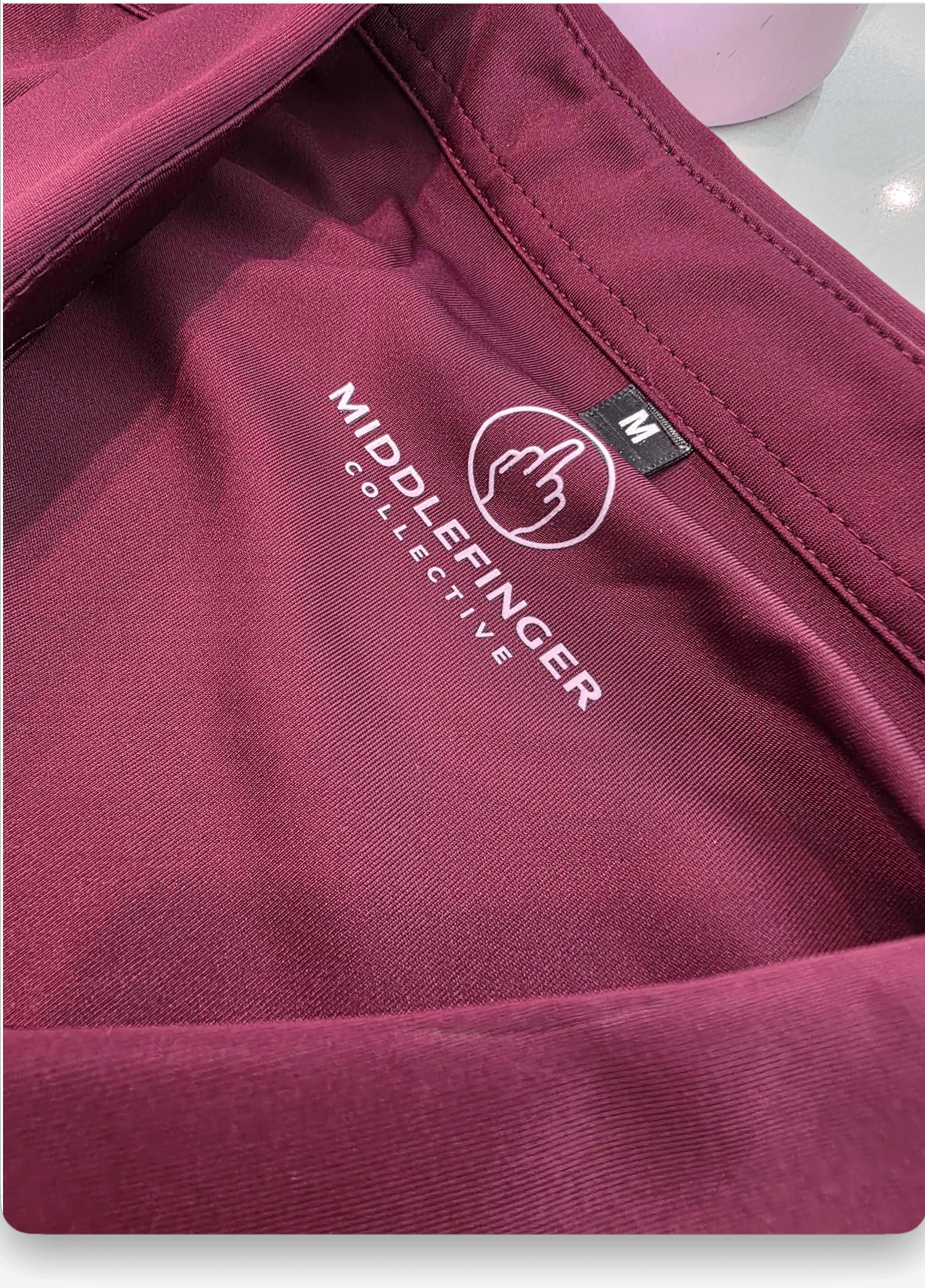 Middlefinger Collective Stretch Button-Up in maroon, interior logo detail